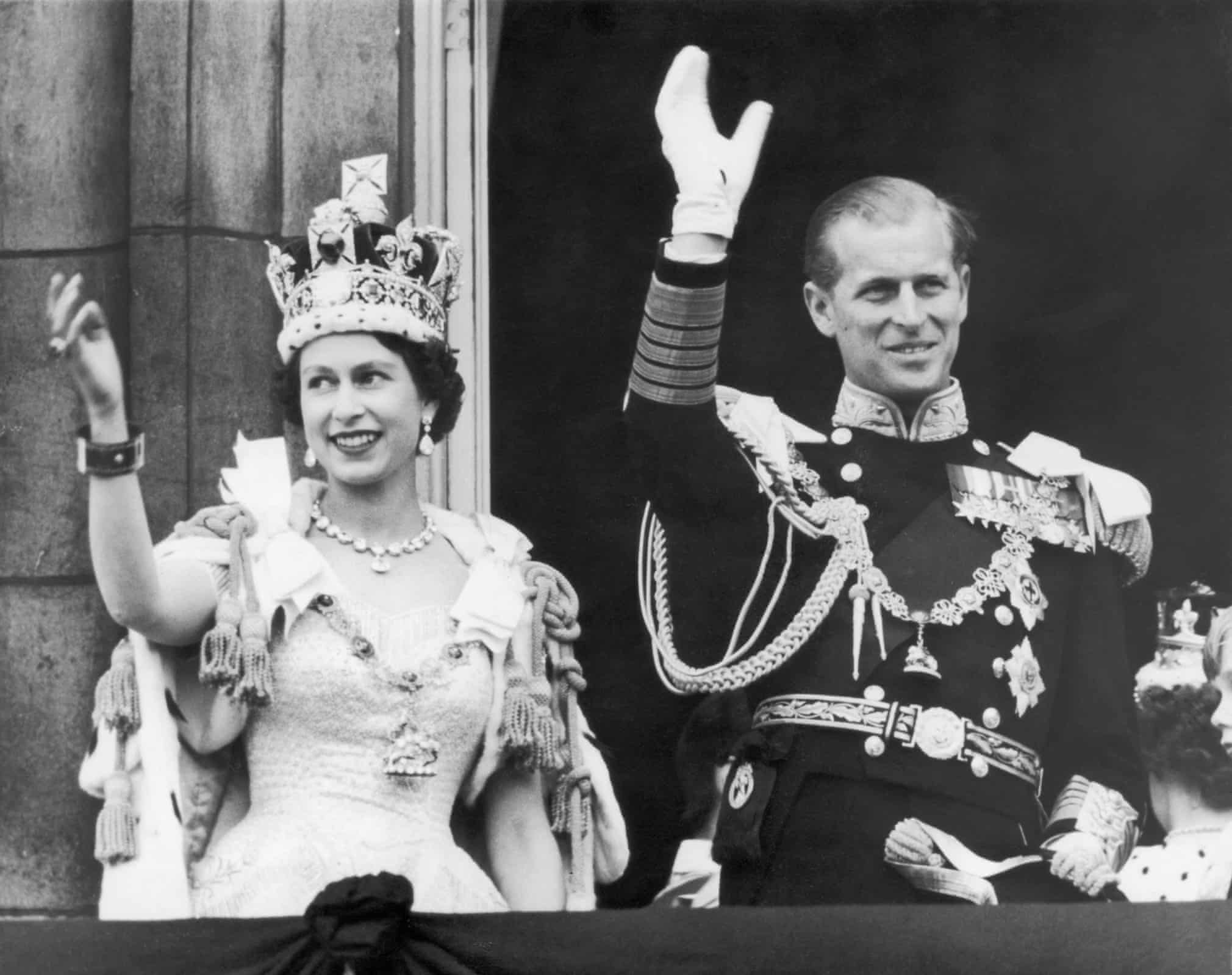 Queen Elizabeth II and the Duke of Edinburgh wave to the crowds from the balcony at Buckingham Palace after the coronation in 1953. Photograph: Keystone/Getty Images