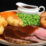British roast beef dinner with Yorkshire puddings.