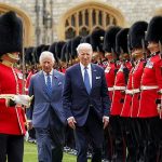 President Biden walks in front of King Charles as the pair inspect the Welsh Guards at Windsor Castle today