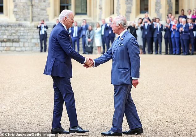 The US President, 80, was seen shaking hands with the 74-year-old monarch before they made their way to the castle lawn for a rendition of the US national anthem courtesy of the Welsh Guards