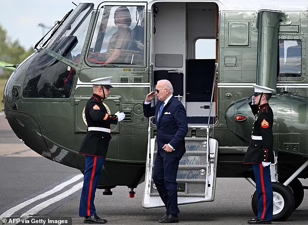 President Joe Biden disembarks from Marine One to board Air Force One at Stansted airport after meeting the King